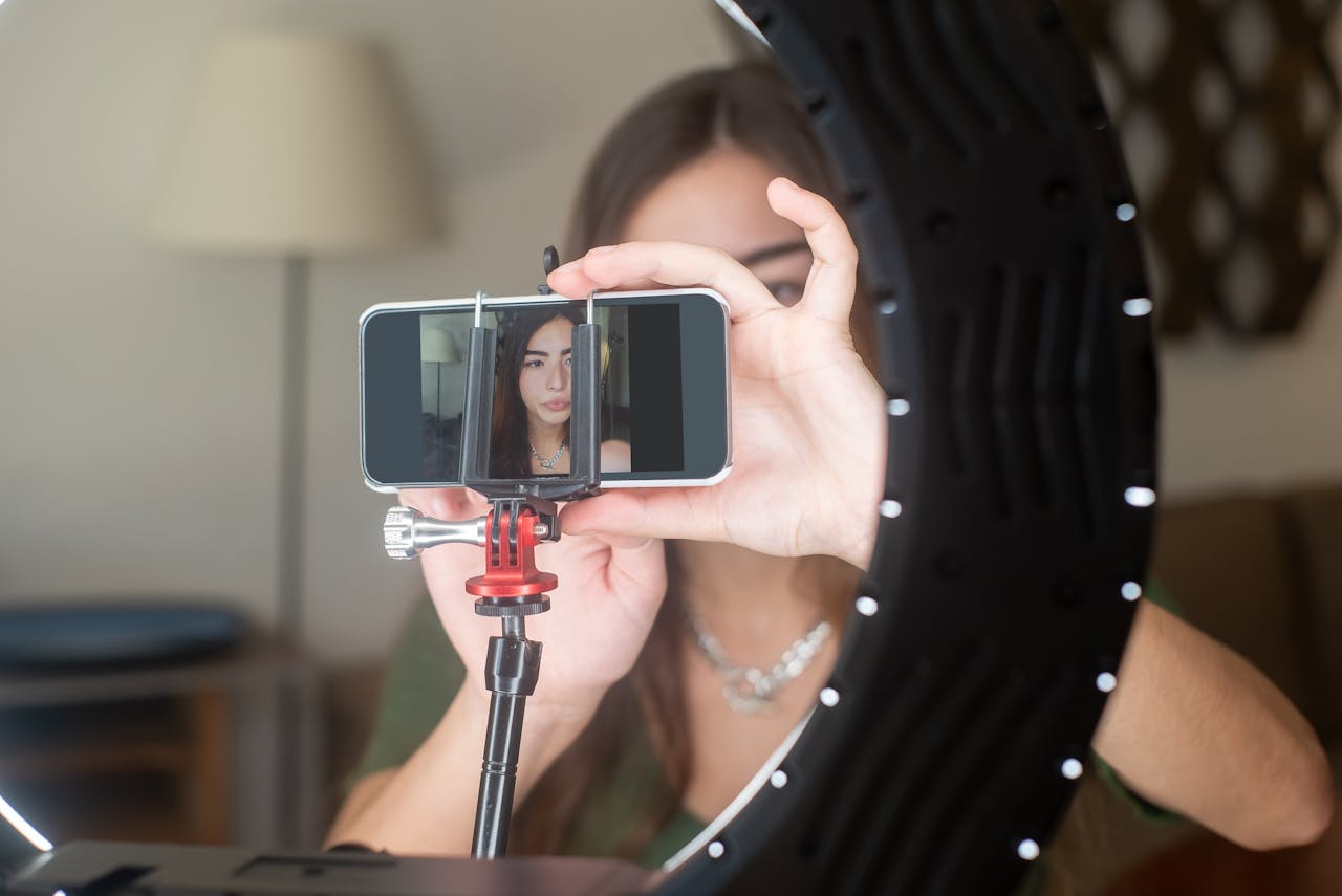 A Woman Vlogger Setting up Her Smartphone